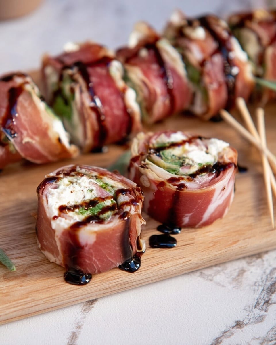 The image shows a long roll sliced into several pieces, each wrapped with thin reddish-pink prosciutto. Inside each slice, there is a creamy white cheese layer mixed with green herbs, topped with a drizzle of dark brown balsamic glaze creating fine lines. The slices are arranged on a light textured wooden board, with two pieces in the front standing upright to clearly show their inside layers. To the side, there are a few light wooden toothpicks resting on the board. The background is a white marbled texture. photo taken with an iphone --ar 4:5 --v 7