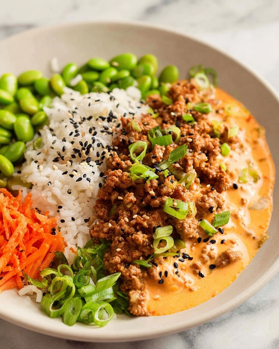 The dish is served on a white plate placed on a white marbled surface. It has four main layers: on the left, there is white rice topped with black sesame seeds; next to the rice is a layer of bright green edamame beans; beside the beans is a portion of finely chopped orange carrots; and the largest layer on the right consists of cooked ground meat covered with a creamy orange sauce, sprinkled with chopped green onions and more black sesame seeds. The textures range from the soft, fluffy rice to the creamy sauce and crunchy fresh vegetables. Photo taken with an iphone --ar 4:5 --v 7