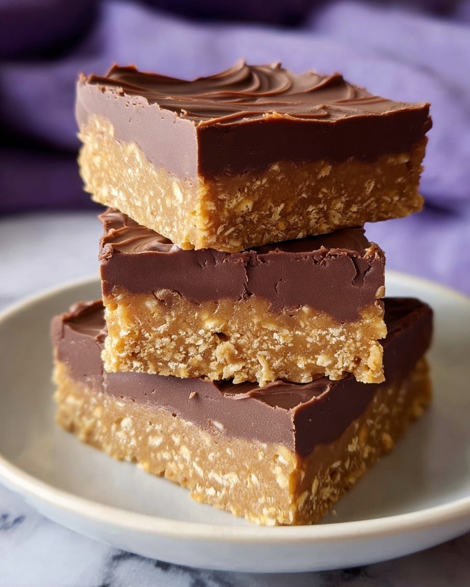 The image shows three square bars stacked on a white plate with a white marbled surface underneath. Each bar has two layers: a thick bottom layer with a rough, grainy texture in a light golden brown color, and a smooth, thick top layer of dark brown chocolate. The top chocolate layer has slight wave patterns on the surface, showing a creamy texture. In the background, a soft purple cloth is partially visible, adding a gentle contrast to the scene. photo taken with an iphone --ar 4:5 --v 7