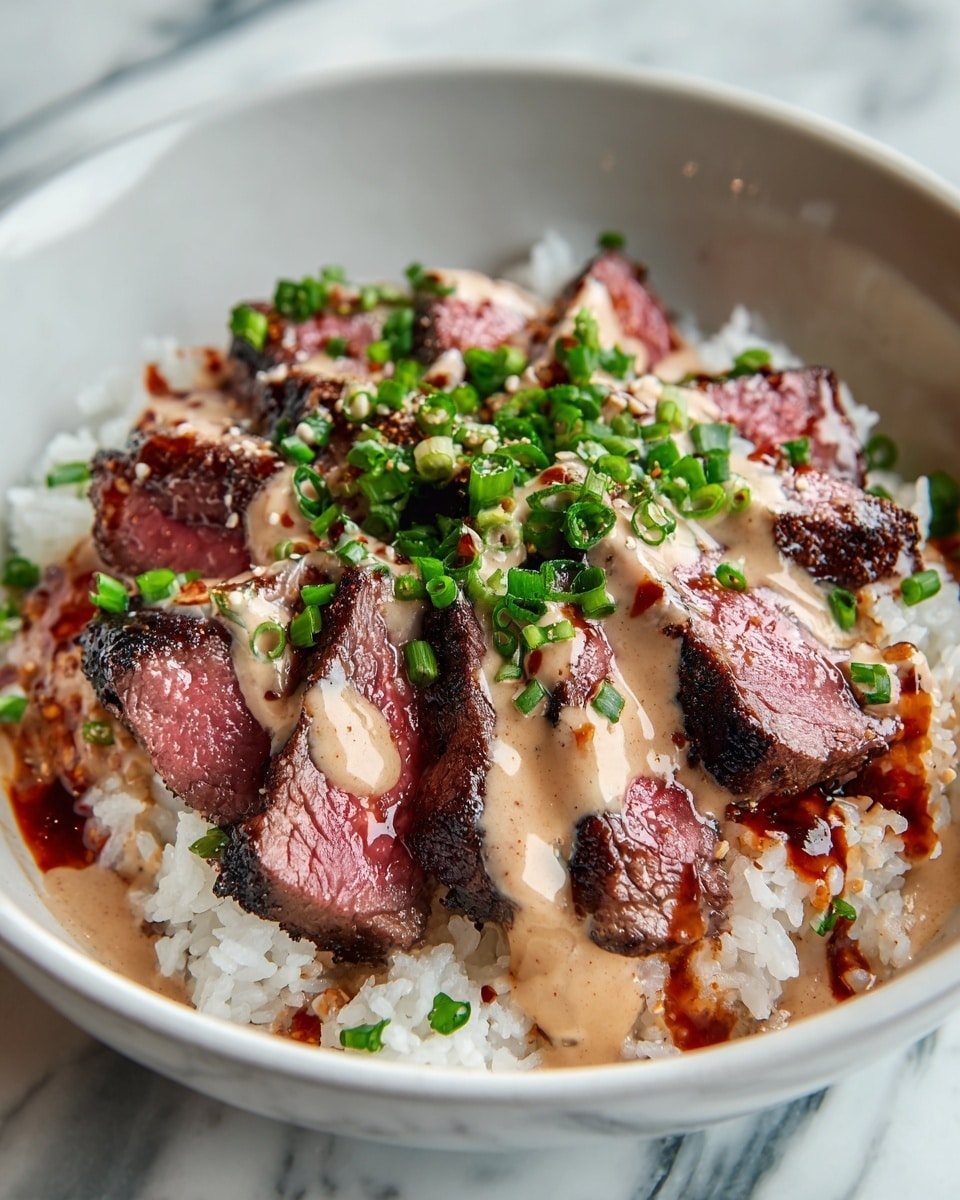 A black bowl filled with a base layer of white rice that is soft and slightly sticky in texture. On top of the rice are thick slices of grilled steak, showing a mix of charred dark edges and juicy pink centers spread evenly across the surface. Over the steak, there is a creamy orange sauce drizzled generously, with glossy, darker orange streaks adding contrast. The dish is finished with a fresh topping of finely chopped green onions placed at the center. The bowl sits on a table with a white marbled texture in the background. photo taken with an iphone --ar 4:5 --v 7