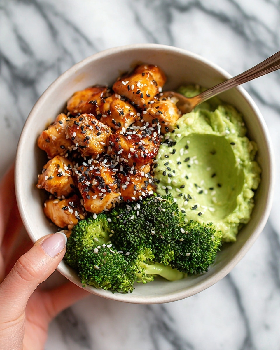 The image shows a close-up of a white plate with a neatly arranged dish of glazed chicken pieces on the left side, each piece golden brown with a shiny, sticky texture and sprinkled with sesame seeds. On the right side, there is a creamy mashed yellow layer, smooth and softly textured, next to steamed green broccoli florets with a fresh, slightly glossy look. The colors contrast nicely: golden brown chicken, bright green broccoli, and pale yellow mash, all sitting on a white marbled surface. Photo taken with an iphone --ar 4:5 --v 7